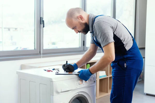 Professional Technician Writing Invoice Repairing Washing Machine Home Repair Concept — Photo