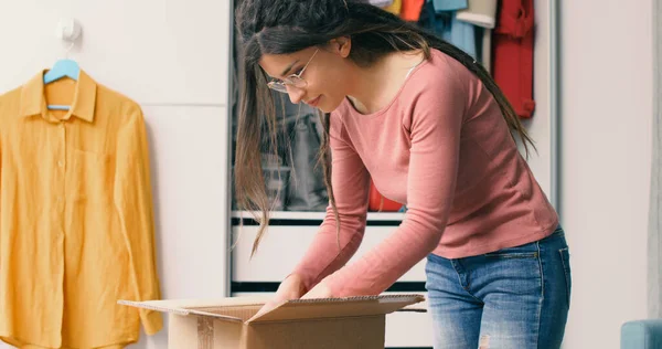 Woman Opening Delivery Box Home — Photo