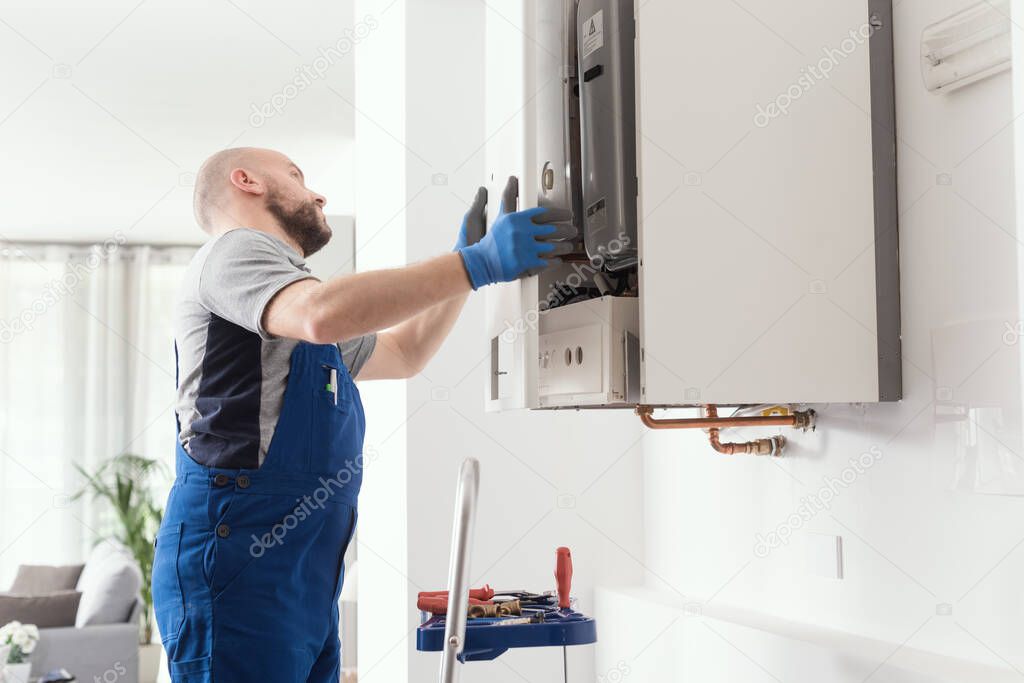 Professional engineer doing a boiler inspection at home