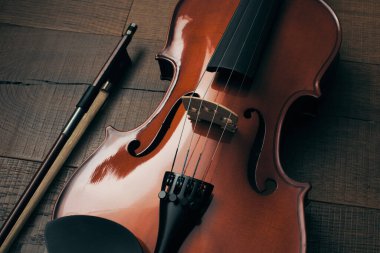 A old violin on a wooden table. Classical Music concept.