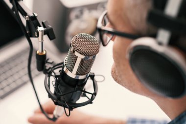 Professional speaker recording a live podcast for his channel, communication and media concept
