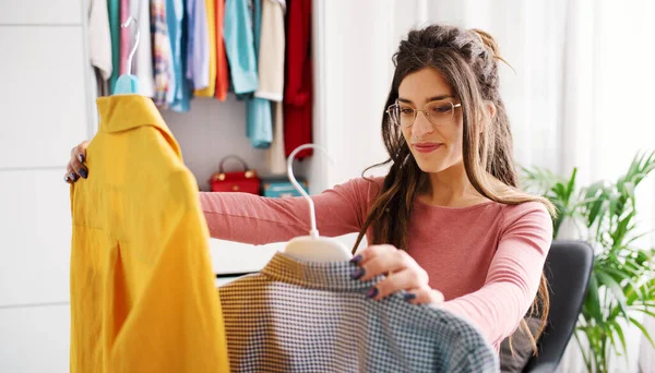 Young Happy Woman Holding Two Shirts Comparing Them She Choosing — 스톡 사진