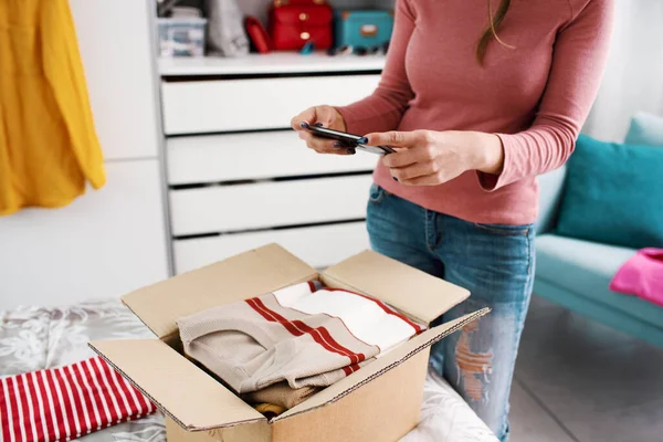 Young Woman Taking Pictures Her Clothes Delivery Box Using Smartphone — Stockfoto