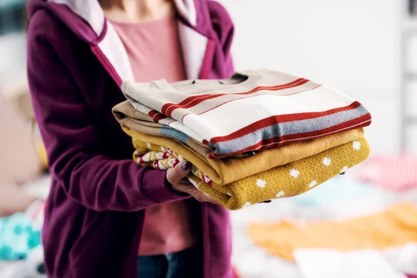 Woman Holding Pile Folded Clothes Clothing Donation Concept —  Fotos de Stock