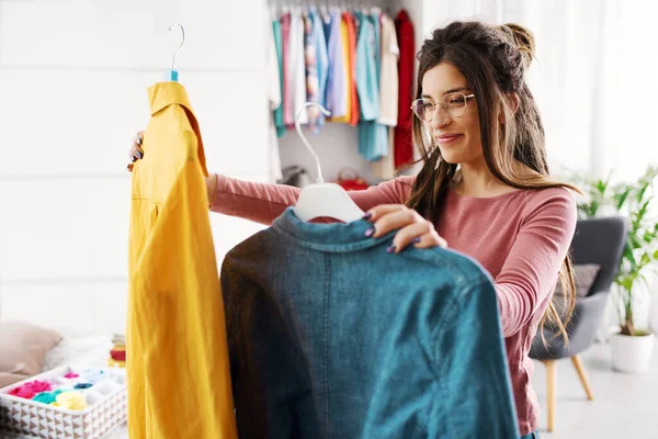 Young Happy Woman Holding Two Shirts Comparing Them She Choosing — Foto Stock