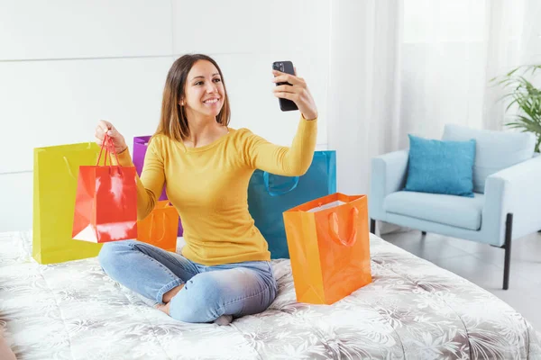 Happy Young Woman Sitting Bed Taking Selfies Her Shopping Bags — 图库照片