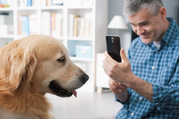 Man Taking Pictures His Cute Dog Home Holding Smartphone Shooting — Stockfoto