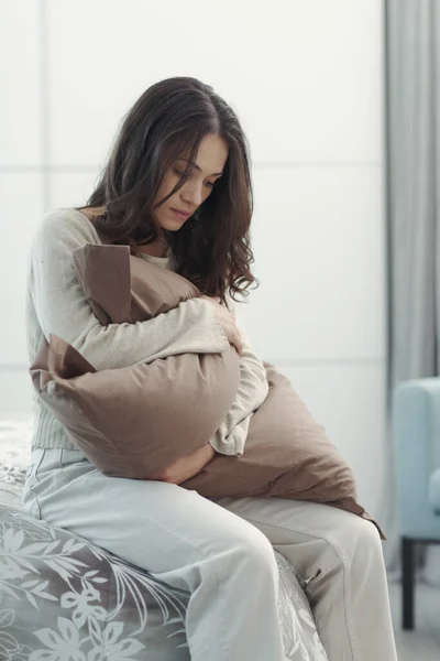 Sad Young Woman Sitting Bed Home She Hugging Pillow Feeling — Stock Fotó