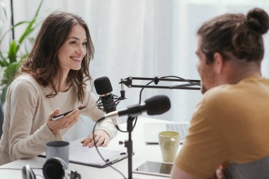 Young professional speaker conducting a live podcast interview, communication and media concept