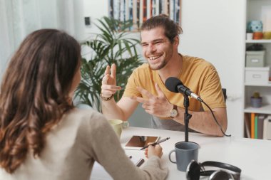 Young professional speaker conducting a live podcast interview, communication and media concept