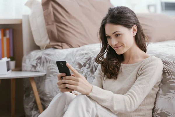 Young Woman Relaxing Bed She Watching Videos Her Smartphone — Stockfoto