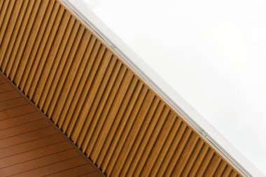 part of brown wood architectural structure and white space background