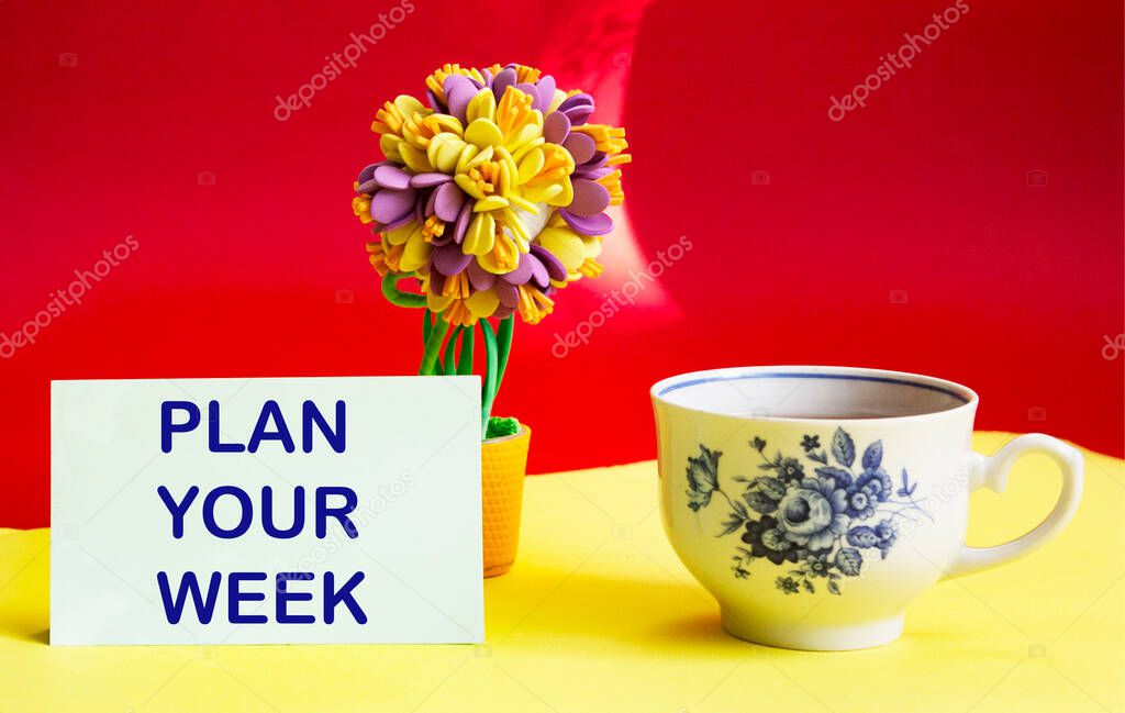 Plan your week highlighted in red on a sticky note posted against a yellow background as a reminder