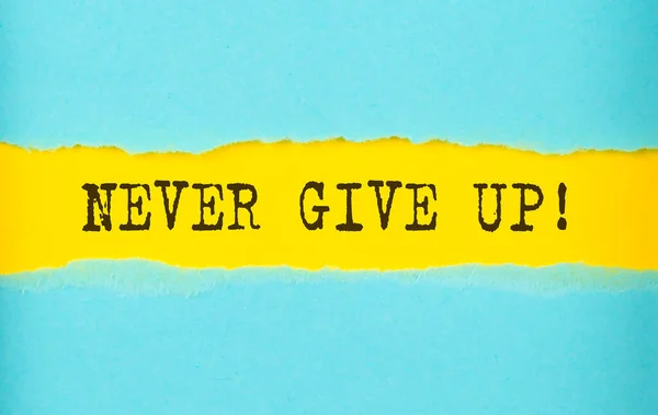 Never Give Text Torn Paper Yellow Background — Stock Photo, Image