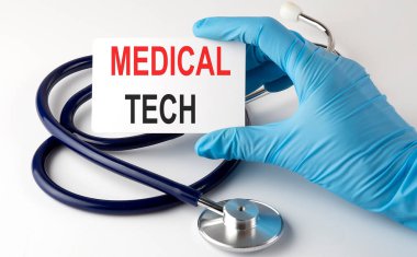 Tech malzemeleri, haplar ve steteskop içeren bir kart. Tıbbi