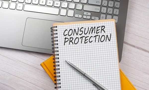 CONSUMER PROTECTION text written on notebook on the laptop,business