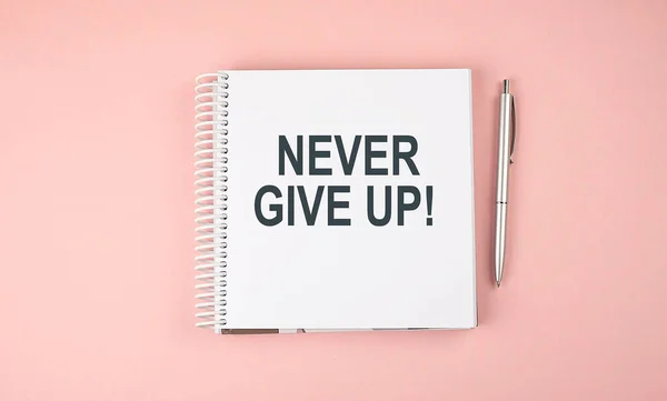 Never Give Text Notebook Pen Pink Background — Stock Photo, Image