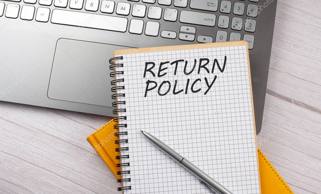 RETURN POLICY text written on notebook on the laptop,business