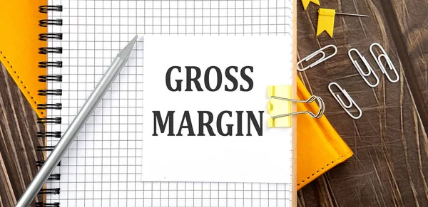 Gross Margin Text Sticker Notebook Wooden Background — Stock Photo, Image