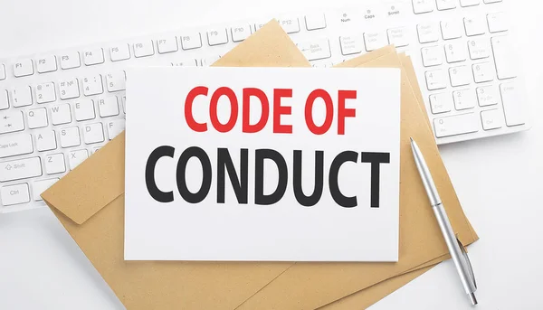 Text CODE OF CONDUCT on envelope on the keyboard