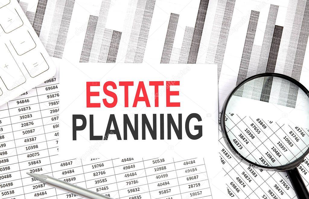 ESTATE PLANNING text on paper with calculator,magnifier ,pen on graph background