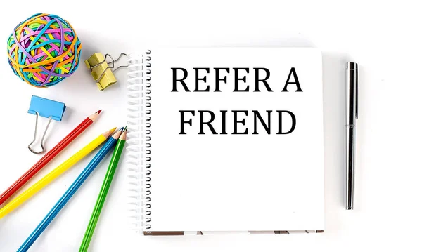 Notebook Pencils Pen Rubber Band Text Refer Friend White Background — Stock Photo, Image