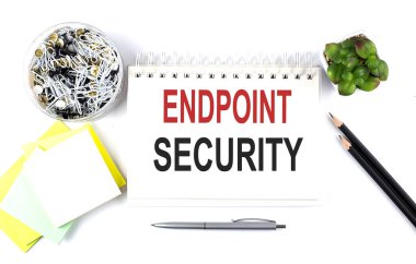 ENDPOINT SECURITY text on notebook with office supplies on the white background