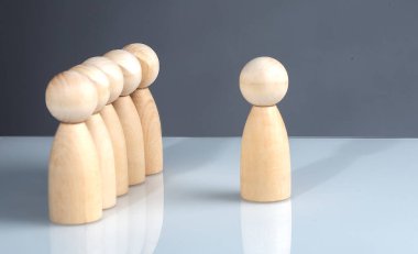 Successful business team leader concept: Wooden figures standing out from crowd