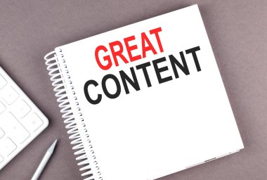 GREAT CONTENT text on notebook with calculator and pen