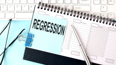Planlama ve klavye üzerinde mavi etiket üzerine REGRESSION metin, mavi arkaplan