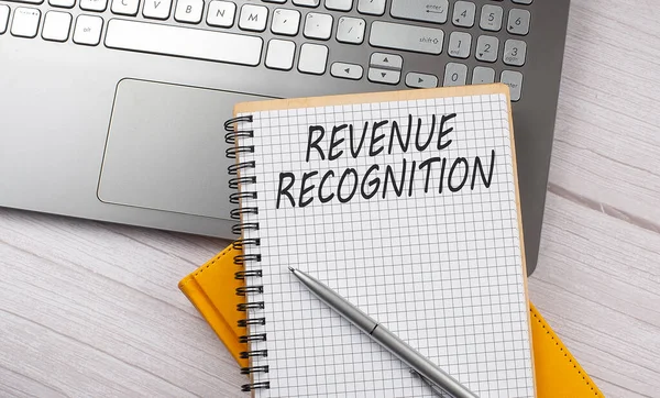 REVENUE RECOGNITION text written on notebook on the laptop