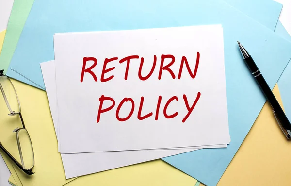RETURN POLICY text on paper on colorful paper background