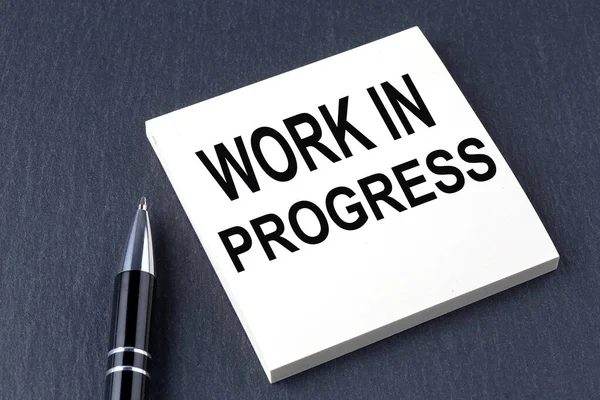 Work Progress Text Sticker Pen Black Background — Stock Photo, Image