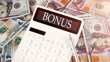 Dolar arkaplanı üzerinde bir ekran hesap makinesi üzerindeki BONUS metni