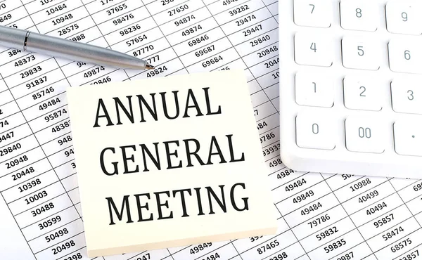 ANNUAL GENERAL MEETING - business concept, message on sticker on a chart background