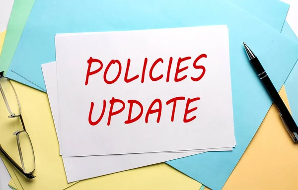 POLICIES UPDATE text on paper on colorful paper background