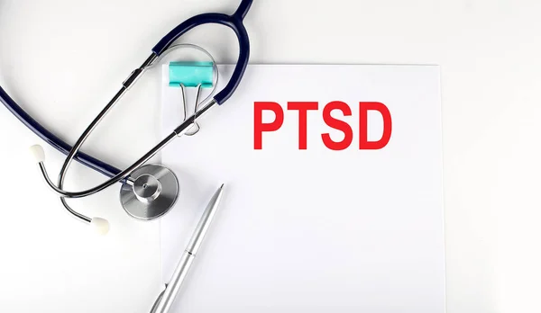 PTSD text written a on paper with a stethoscope. Medical concept.