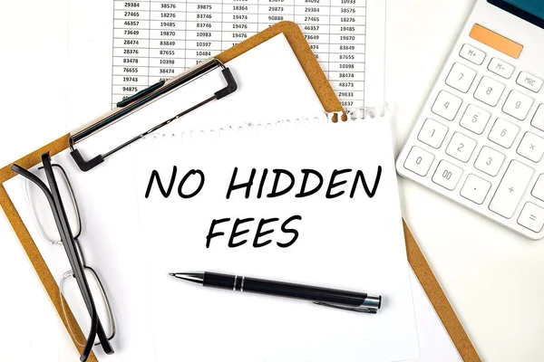 Text NO HIDDEN FEES on white paper on clipboard with chart and calculator