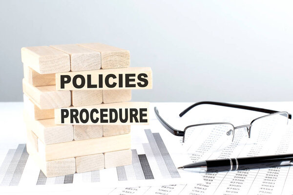 POLICIES PROCEDURE is written on a wooden blocks on a chart background