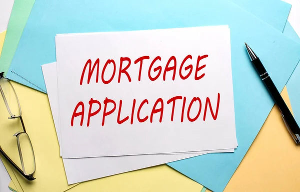 MORTGAGE APPLICATION text on paper on colorful paper background