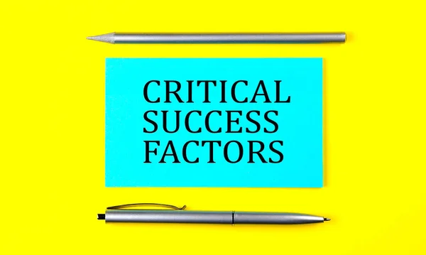 text CRITICAL SUCCESS FACTORS on blue sticker on the yellow background