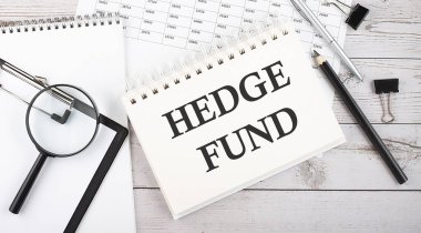 Hedge Fung. Ofis araçları ve belgelerle birlikte bir not defterine yazılan metin.