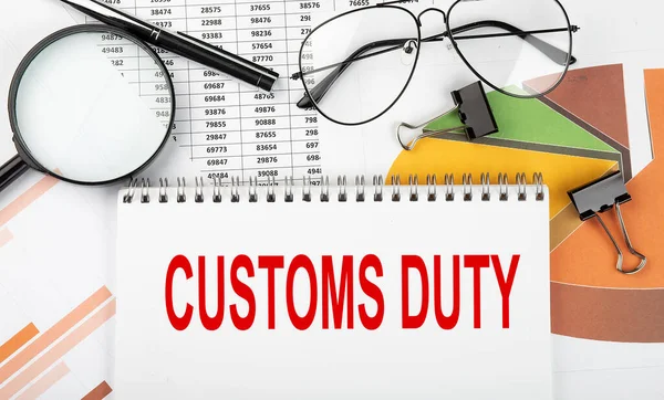Text CUSTOMS DUTY on a white paper notebook on the diagram. Business concept