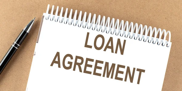 LOAN AGREEMENT text on notepad with pen, business concept