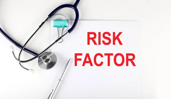 RISK FACTOR text written on paper with a stethoscope. Medical concept.