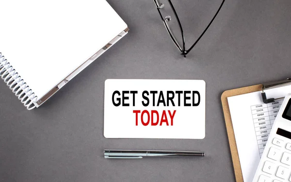 GET STARTED TODAY text written on card with notebook and clipboard, grey background