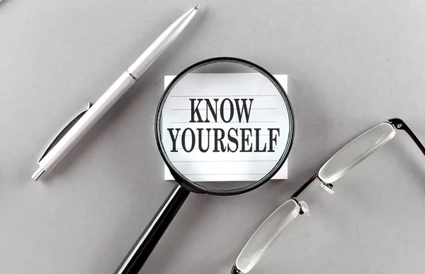 KNOW YOURSELF text written on a sticky with pencil and glasses text written on sticky with pencil and glasses