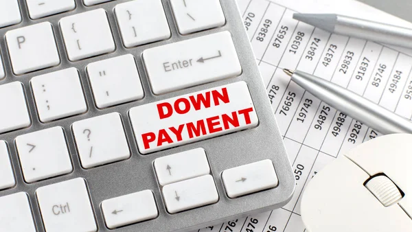DOWN PAYMENT text on keyboard wirh chart and pencil