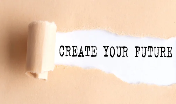 The text CREATE YOUR FUTURE appears on a torn paper on white background.