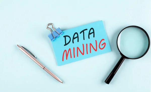 DATA MINING text written on sticky with magnifier and pen, business concept
